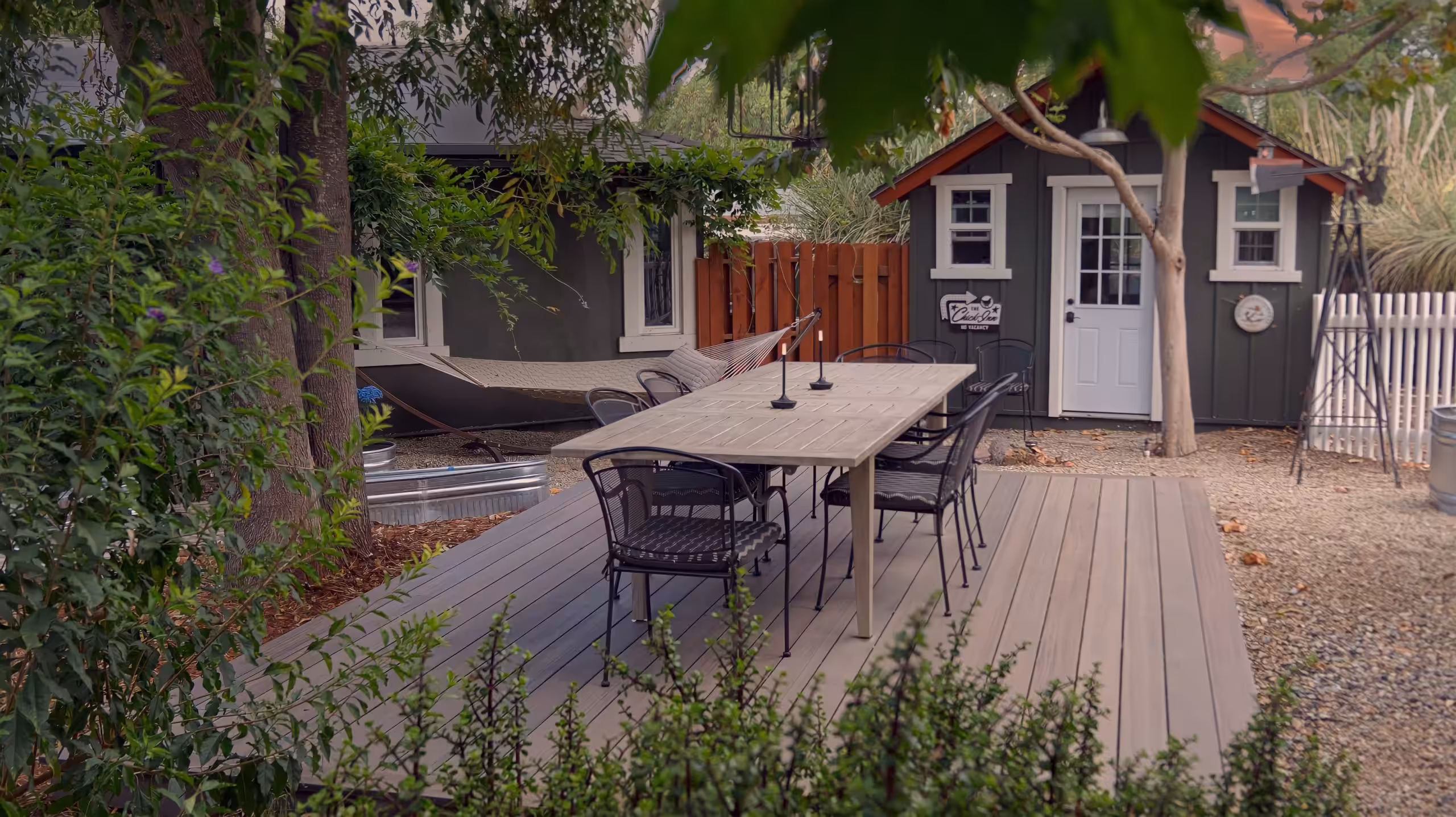 A 2026 deck styled as an outdoor room with warm-tone boards and built-in seating