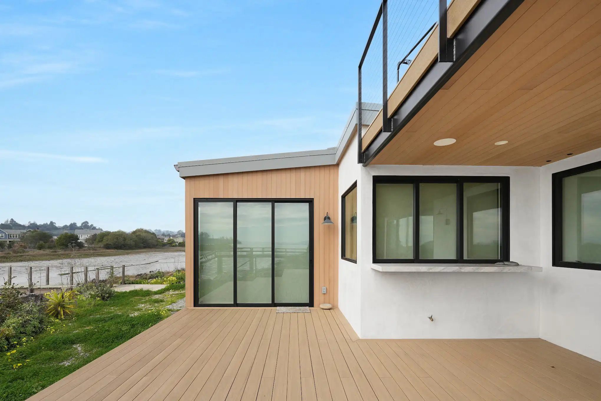 Modern Mill ACRE composite soffit boards on coastal home overhang with vertical shiplap siding and deck
