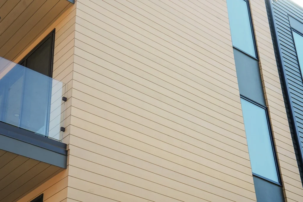 Close-up of horizontal ACRE rice-hull composite siding on a multifamily facade