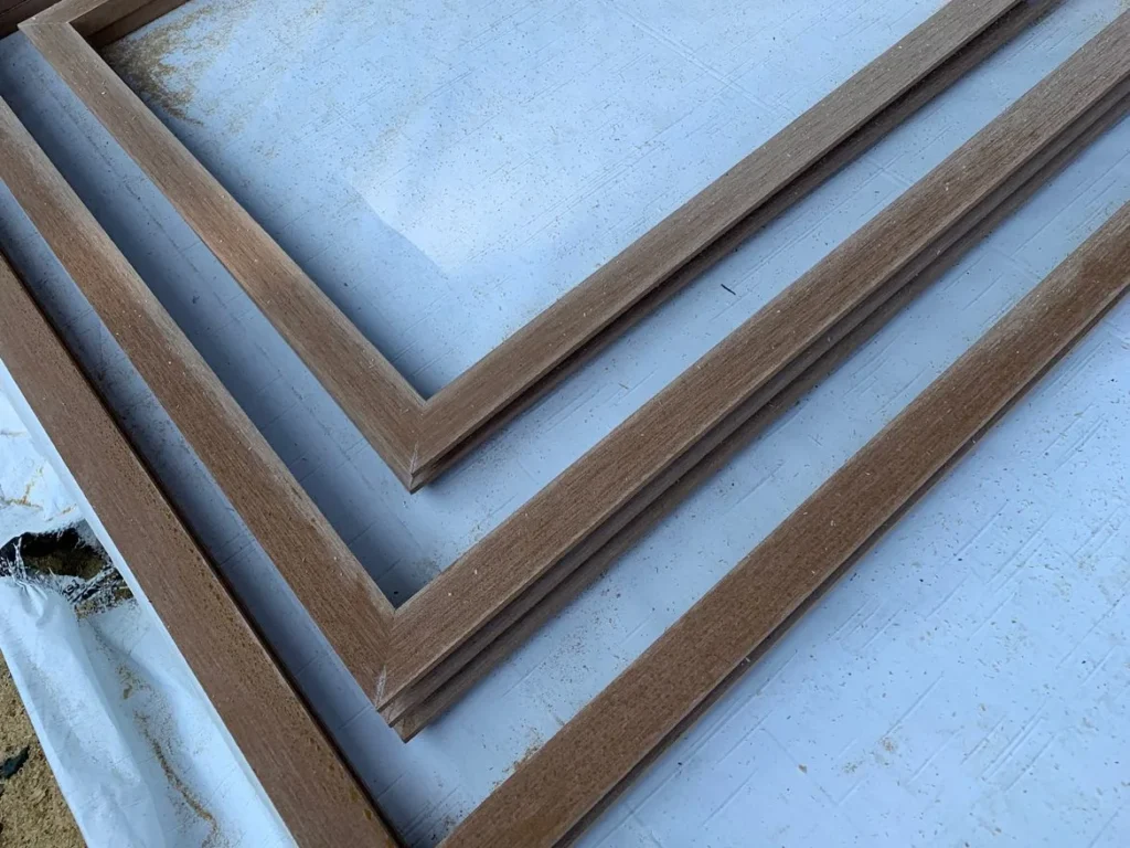 Mitered ACRE rabbeted trim window surrounds laid out before installation