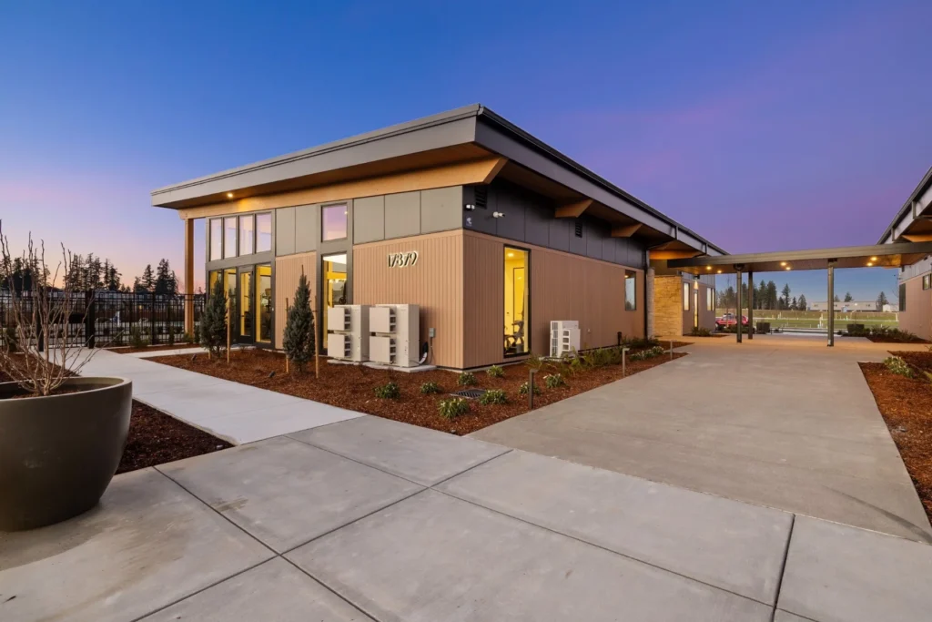 ACRE composite siding on a low-rise community building at dusk