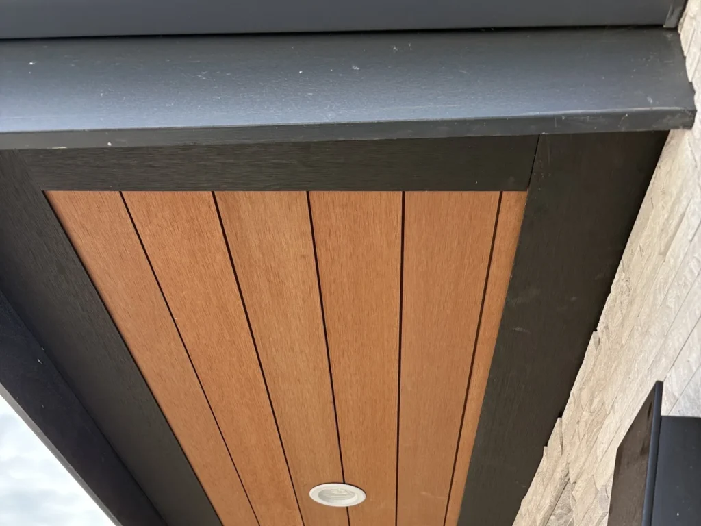 ACRE composite soffit boards under a roof eave with a recessed light