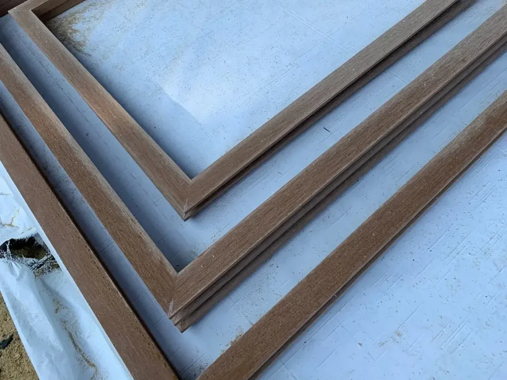 Mitered ACRE rabbeted trim window surrounds laid out before installation