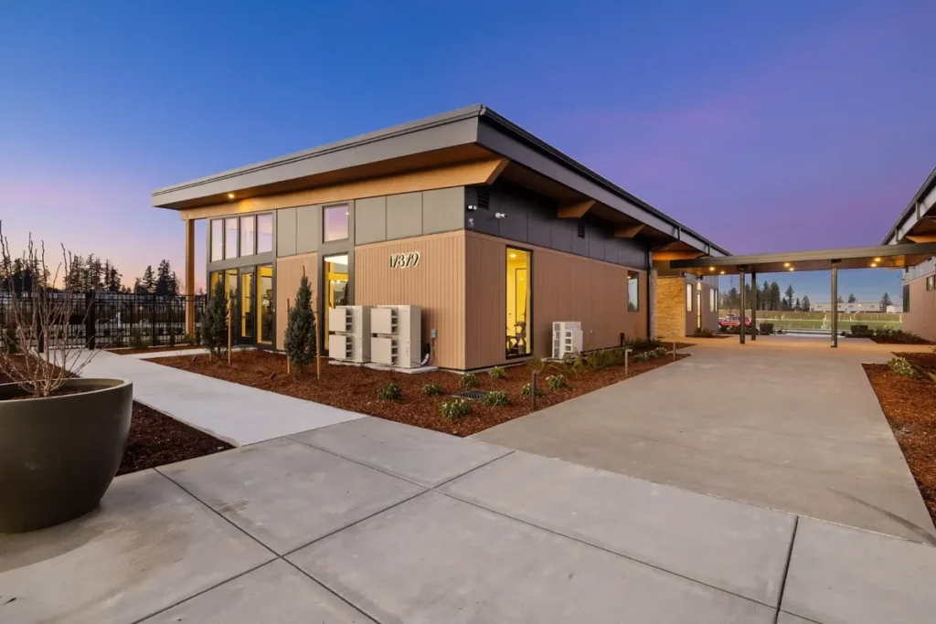 ACRE composite siding on a low-rise community building at dusk